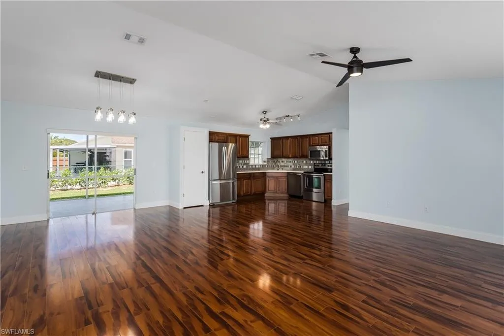 Open concept living and kitchen with vaulted ceilings